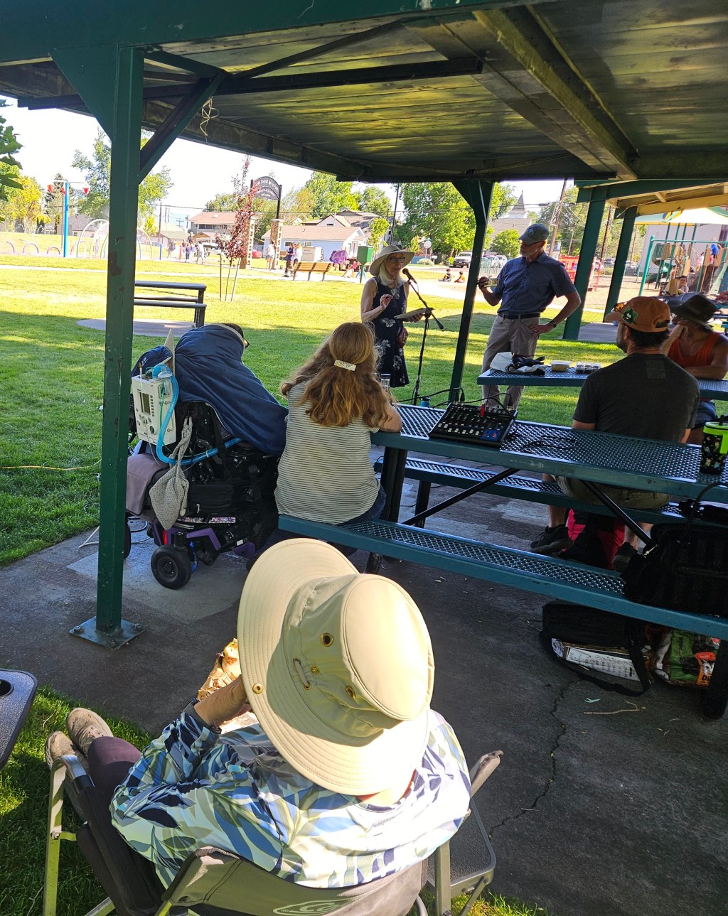 Robyn Morrison speaking at a picnic in the park on June 14th